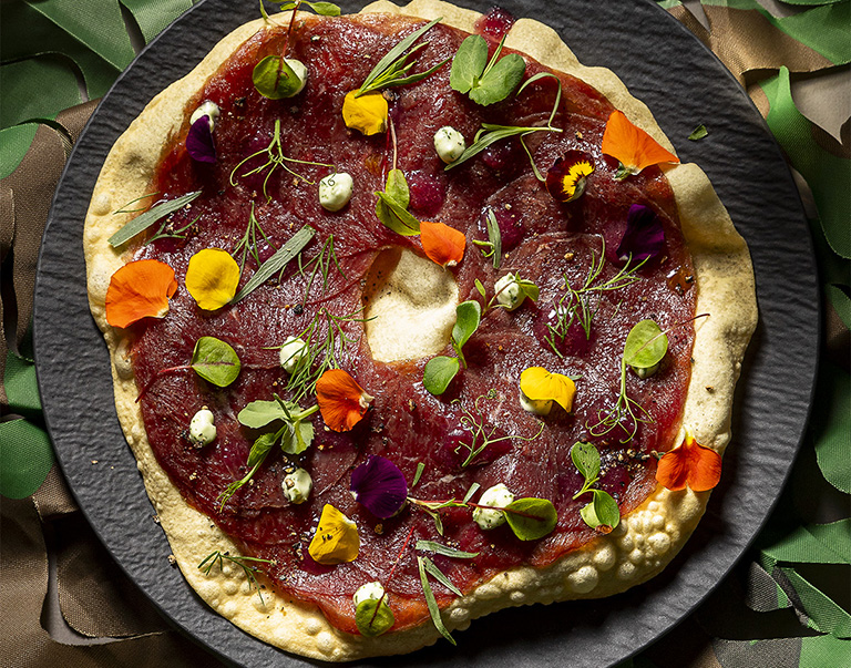 Carpaccio de cerf avec papadums croustillants, délicate mayonnaise aux herbes et confiture de figues. Une entrée savoureuse et élégante.